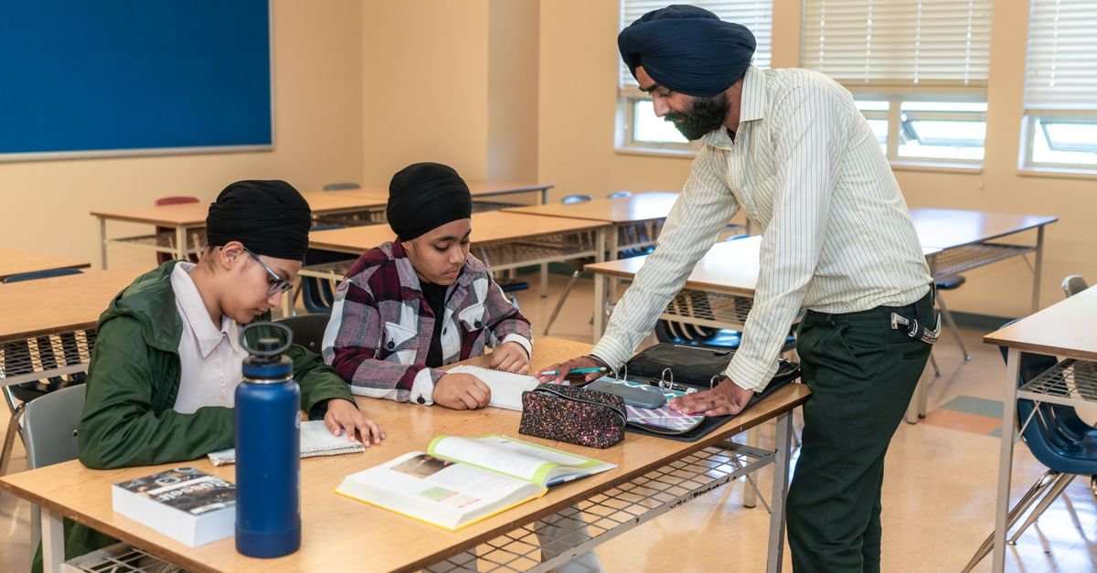 Tutor helping a student one-to-one with maths work