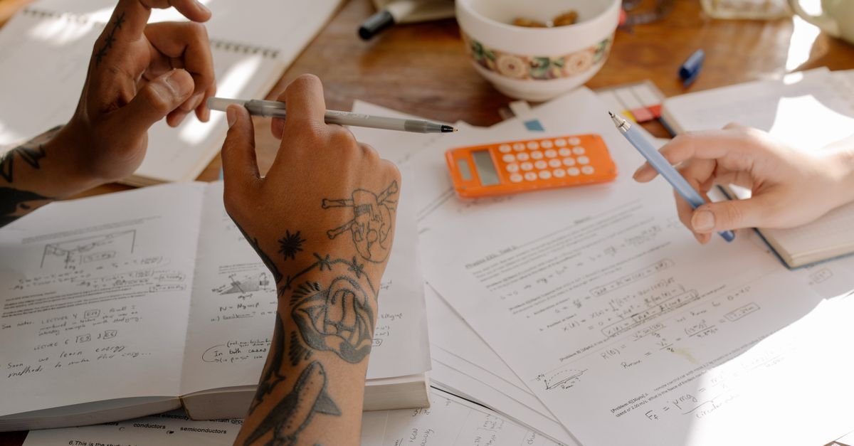 A-level student working through maths problems with a tutor