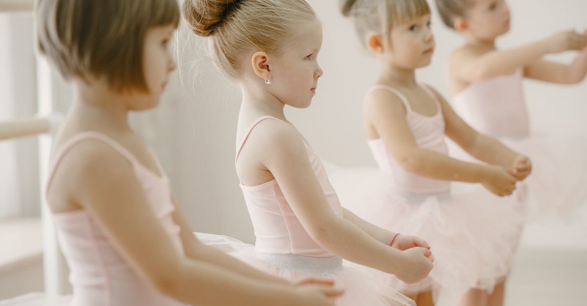 Young children dancing ballet in a bright studio