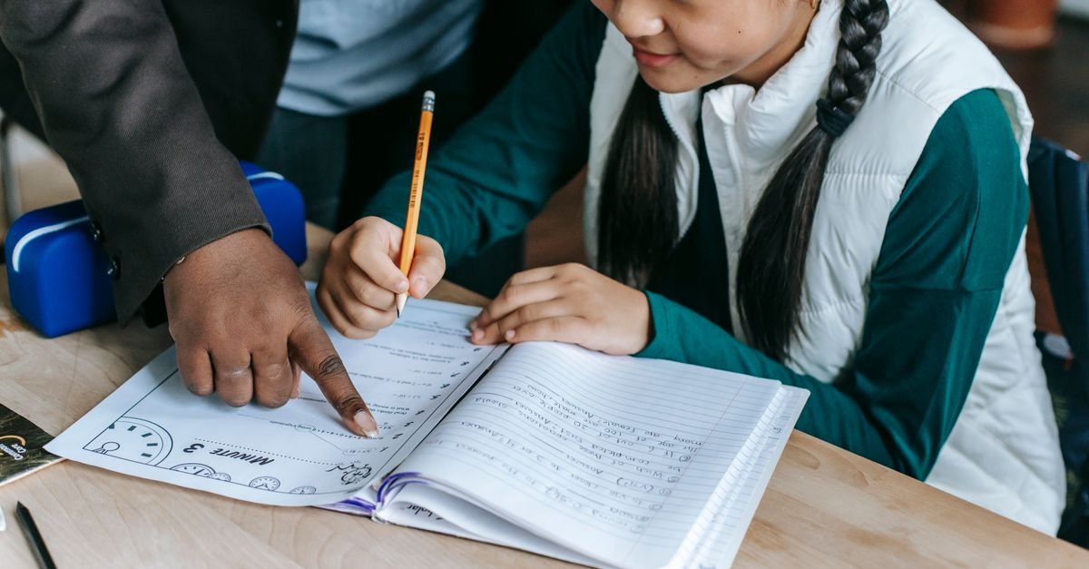 Tutor reviewing an 11+ practice paper with a student