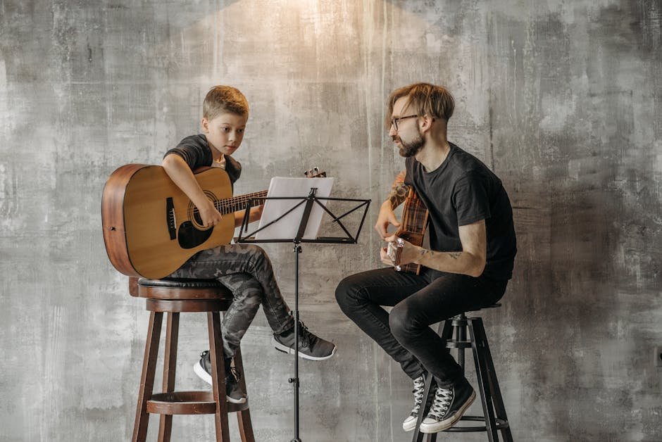 Picture of a guitar tutor teaching a child