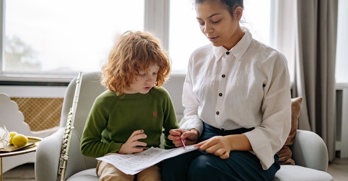 Child working through 11+ practice with a tutor