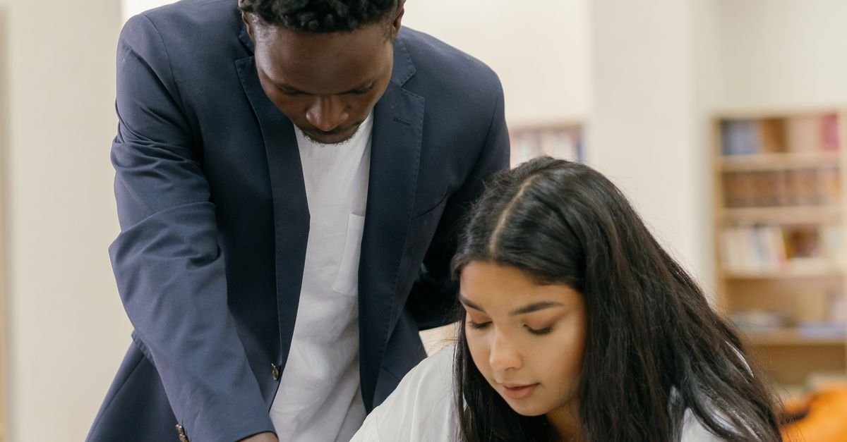 Tutor helping a student with past papers in a small group session at Meridian Tuition